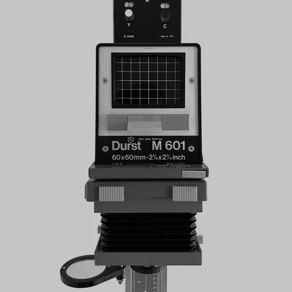A Durst M 601 enlarger, its colour head above the negative stage and bellows, standing on its column.